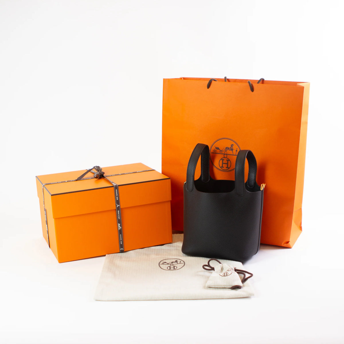 Hermès packaging and a black Picotin bag