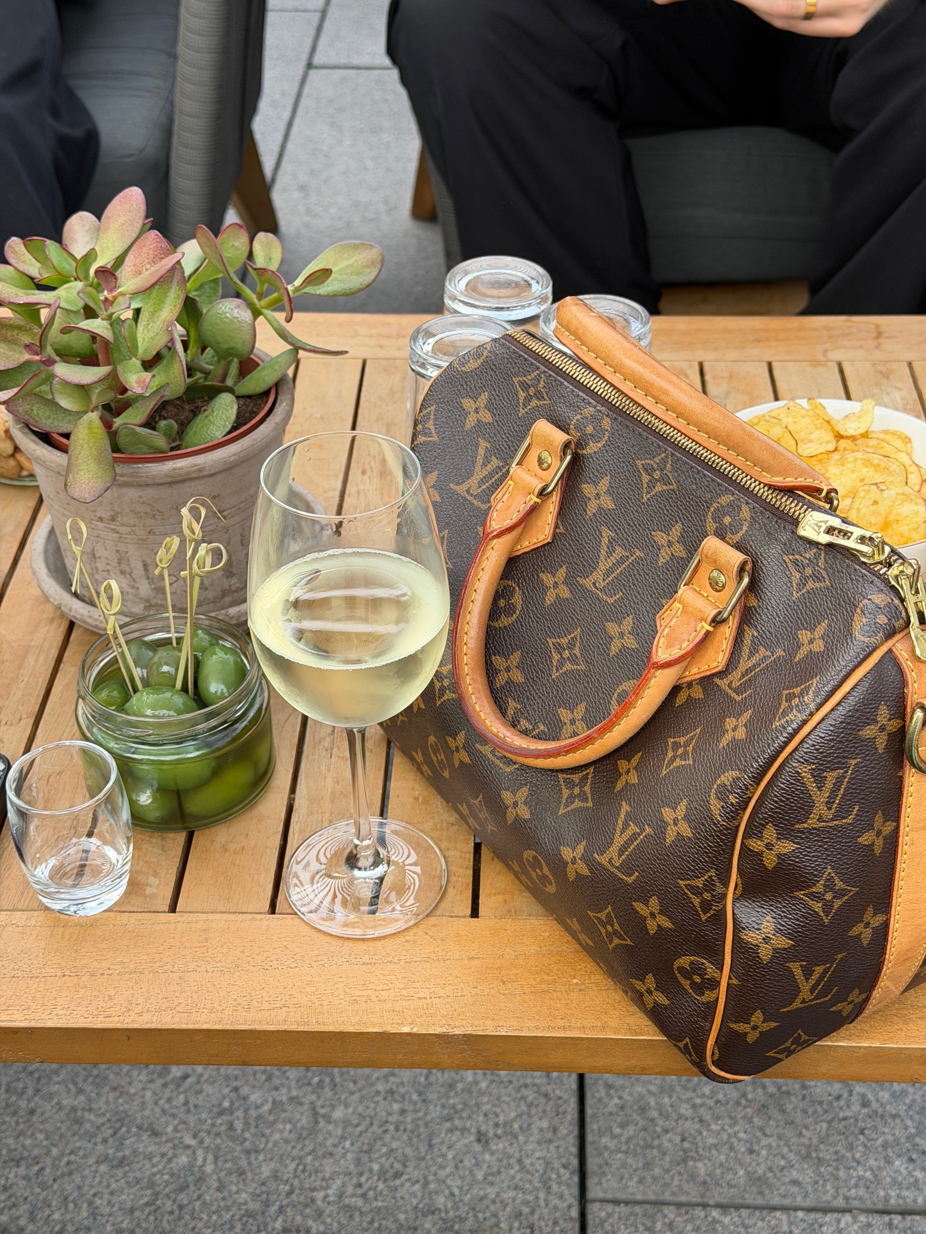 A vintage Louis Vuitton bag styled in an everyday setting